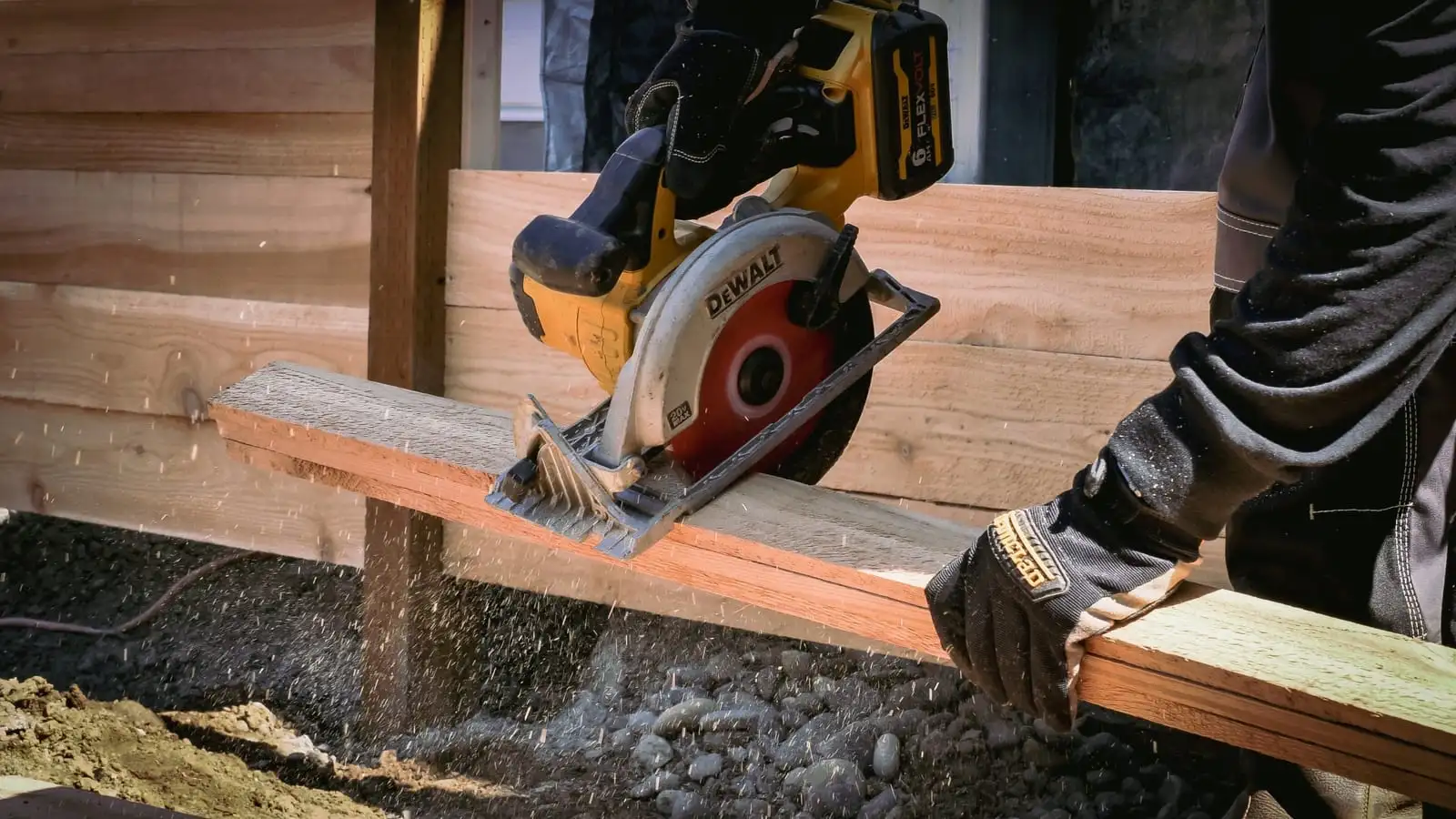 Worker cutting a cedar fence board with a circular saw