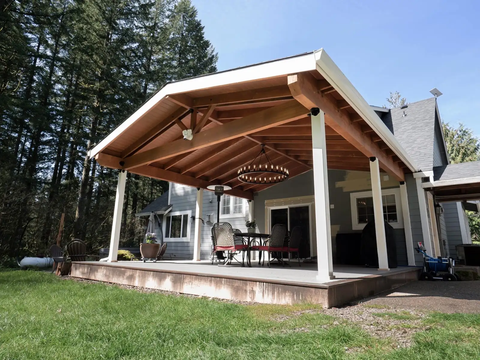 Gable patio cover with exposed wood beams over a concrete patio in Vancouver, WA