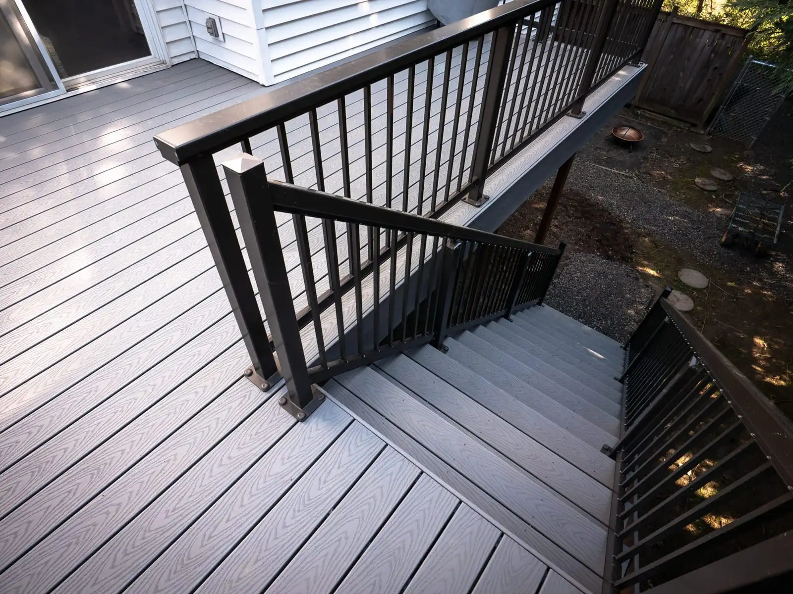 Gray composite deck with black aluminum railing and stairs