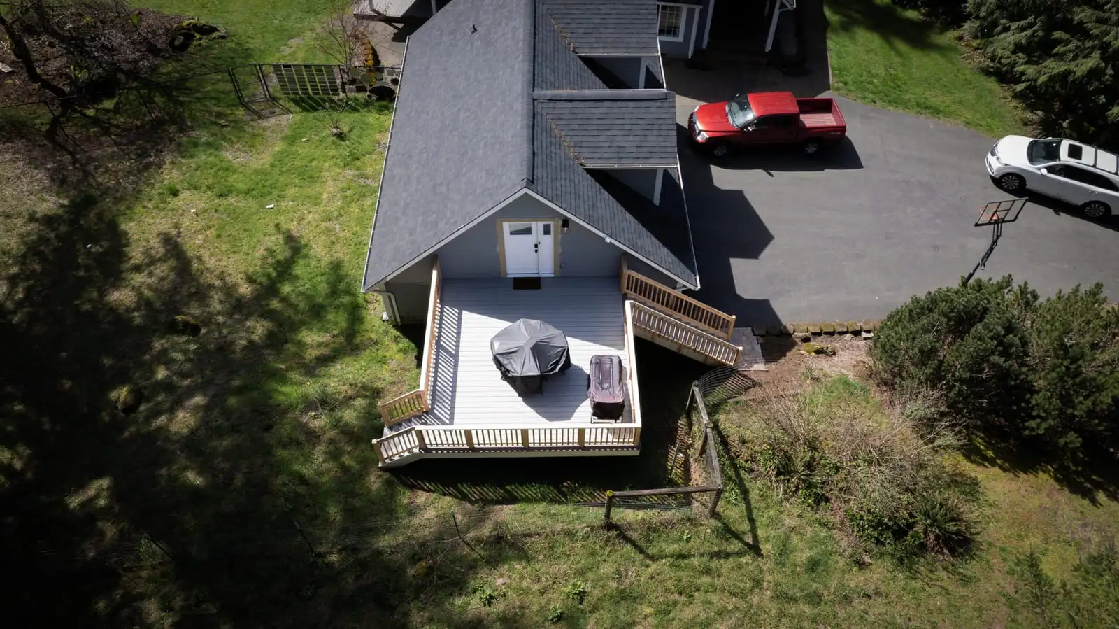 Aerial view of a raised backyard deck with white railing
