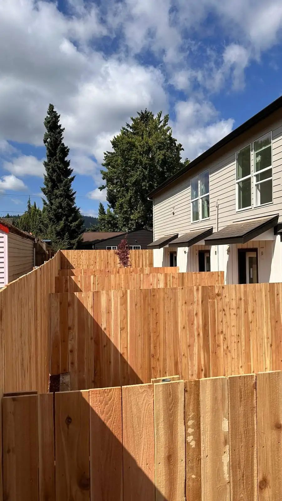 Stepped cedar privacy fence between new townhomes